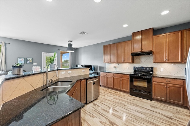 kitchen with light hardwood / wood-style flooring, stainless steel dishwasher, electric range, sink, and dark stone countertops