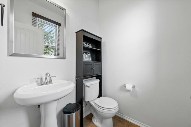 bathroom featuring tile patterned flooring, toilet, and sink