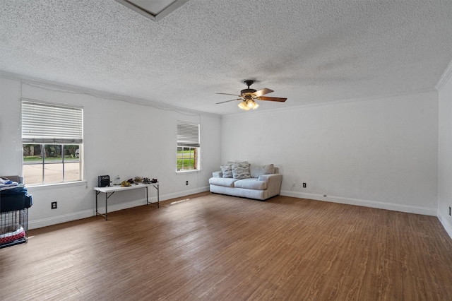 unfurnished room with wood-type flooring, ornamental molding, a healthy amount of sunlight, and ceiling fan