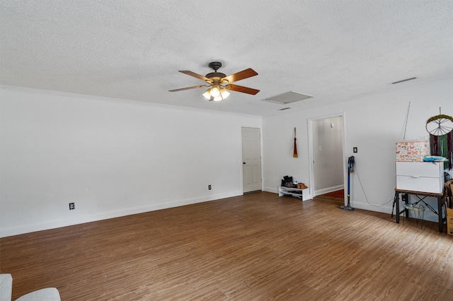 spare room featuring ceiling fan, dark wood-type flooring, and a textured ceiling