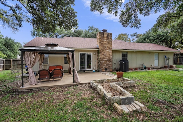 rear view of house with a gazebo, central AC, a lawn, and a patio area