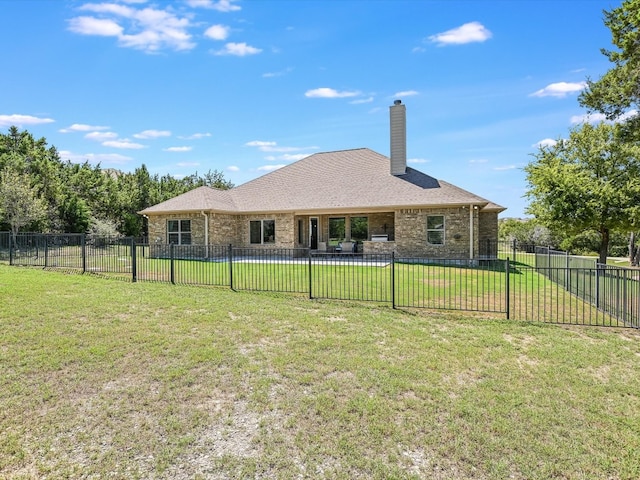 rear view of house with a yard