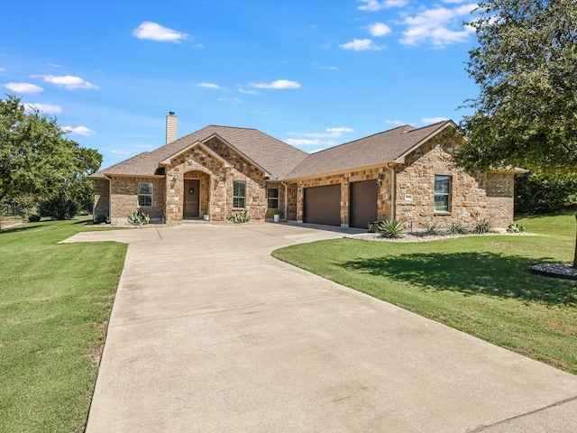 view of front of home with a front yard and a garage