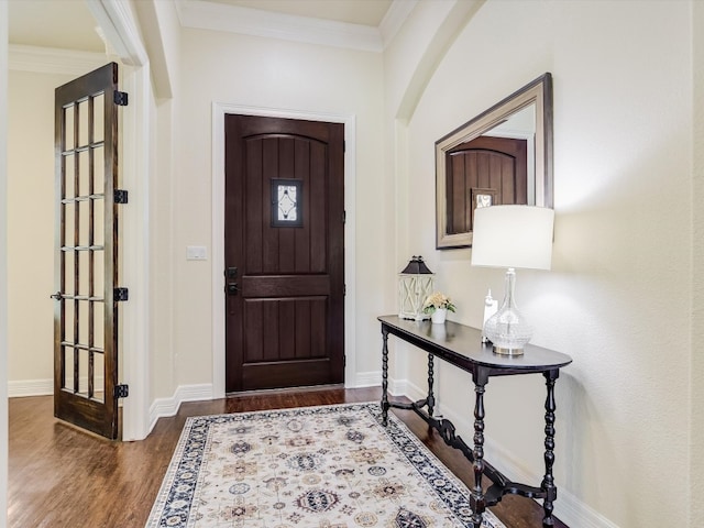 entryway with crown molding and dark hardwood / wood-style floors