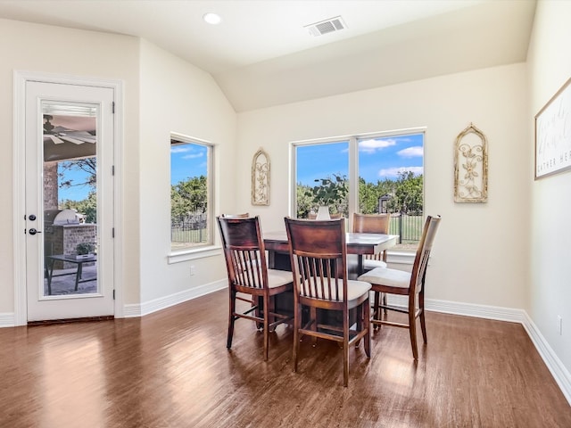 dining area with dark wood-type flooring and lofted ceiling