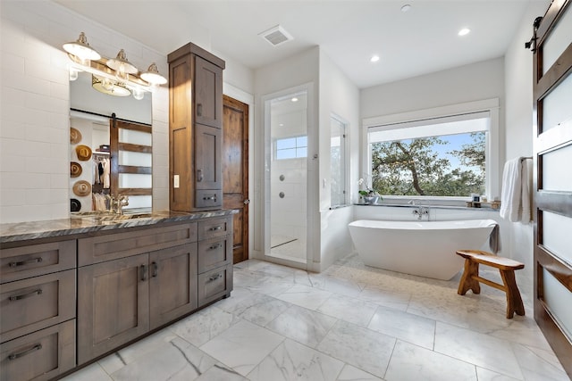 bathroom featuring shower with separate bathtub and vanity