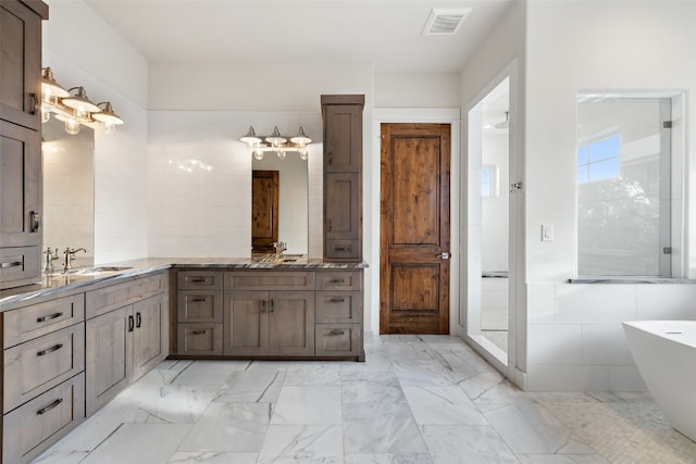 bathroom featuring vanity and a tub