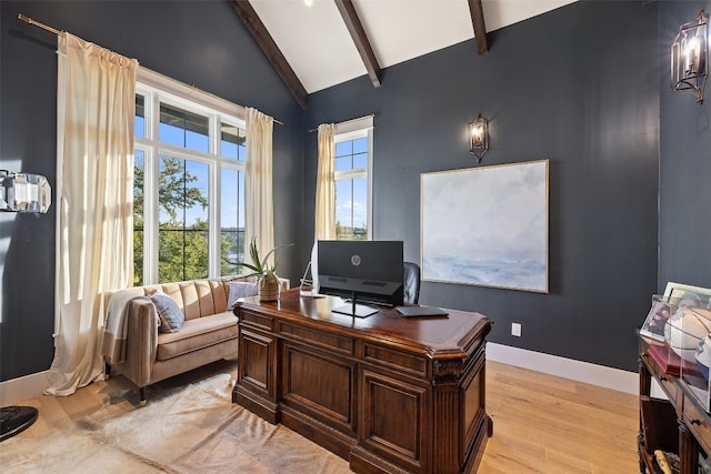 office with high vaulted ceiling, beam ceiling, and light hardwood / wood-style flooring