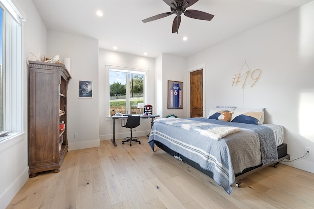 bedroom with ceiling fan and light hardwood / wood-style floors