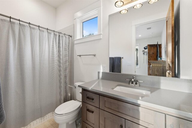 bathroom with vanity, toilet, and a shower with curtain