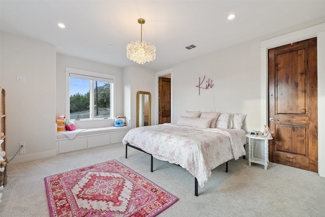 bedroom featuring light colored carpet and a notable chandelier