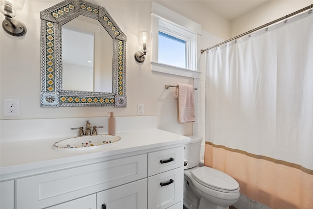 bathroom featuring vanity, toilet, and a shower with curtain