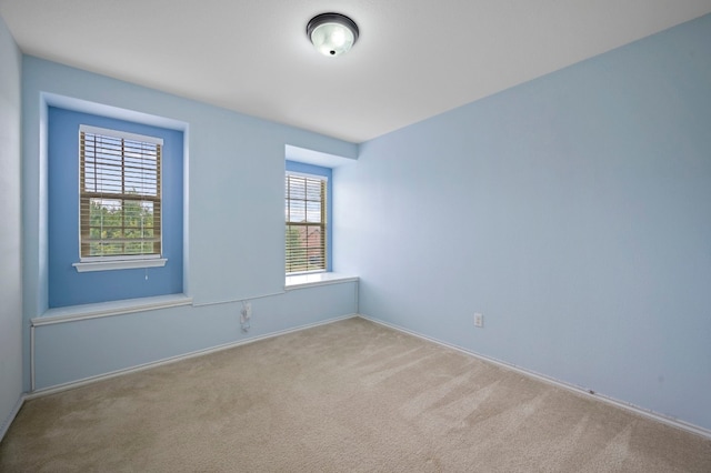 carpeted spare room with a healthy amount of sunlight