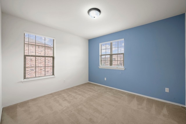 unfurnished room with light carpet