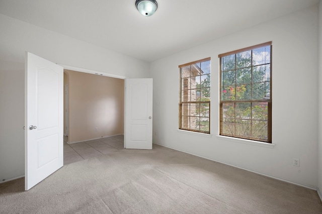 unfurnished bedroom featuring light carpet