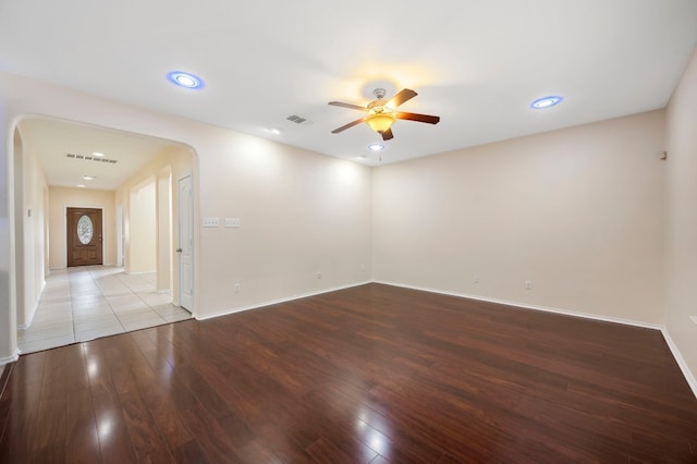 empty room with ceiling fan and hardwood / wood-style flooring