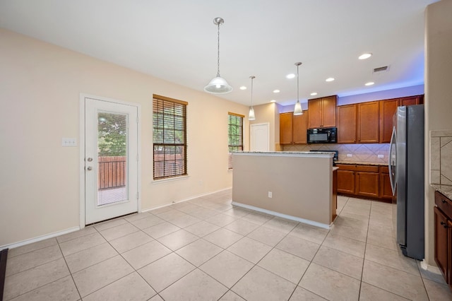 kitchen featuring stainless steel fridge, tasteful backsplash, light tile patterned floors, a center island, and hanging light fixtures