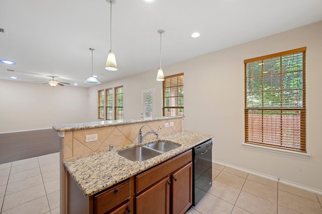 kitchen with dishwasher, sink, ceiling fan, and a center island with sink