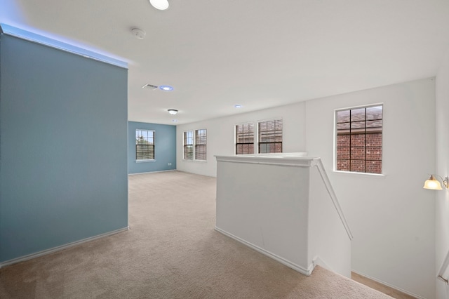 corridor with light colored carpet