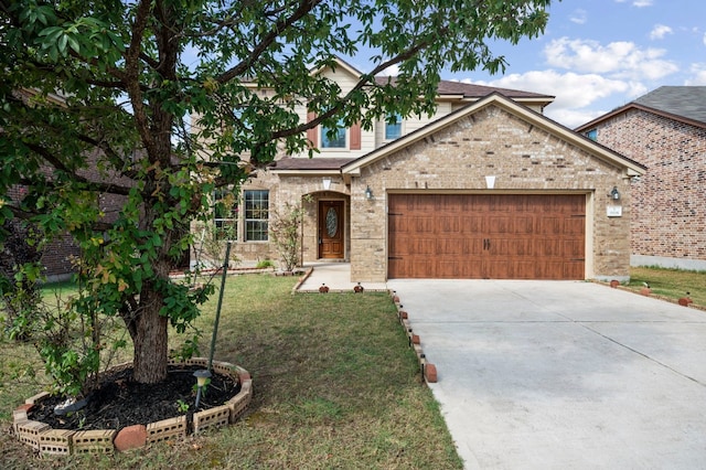 view of front of home featuring a garage and a front yard