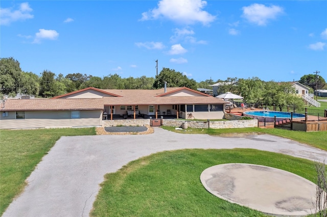 exterior space with a patio area, a swimming pool, and a lawn