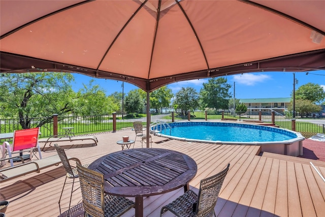 view of pool with a wooden deck and a gazebo