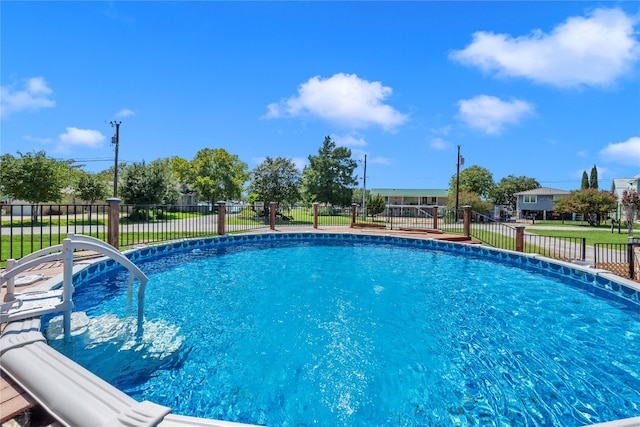 view of pool with a yard