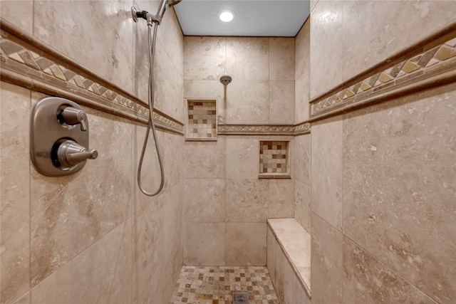 bathroom featuring a tile shower