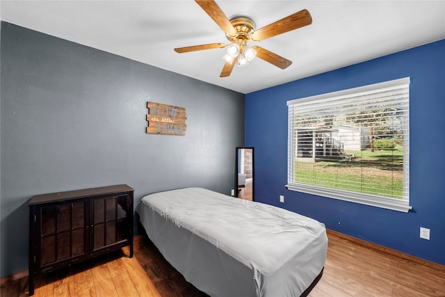 bedroom featuring ceiling fan and wood-type flooring