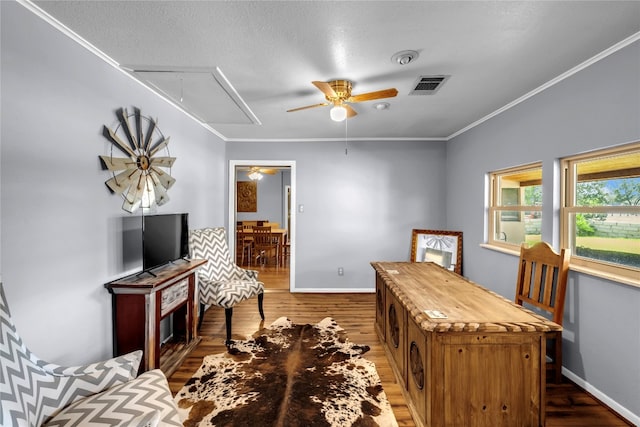 home office with ceiling fan, dark hardwood / wood-style flooring, crown molding, and a textured ceiling