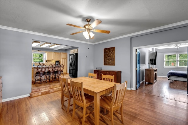 dining room featuring a textured ceiling, ceiling fan, ornamental molding, and wood-type flooring