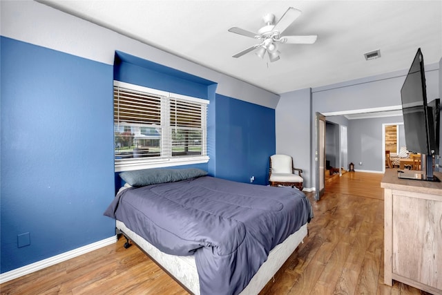 bedroom with ceiling fan and wood-type flooring