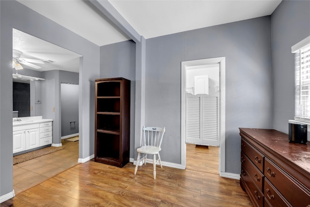 living area with light hardwood / wood-style flooring and ceiling fan