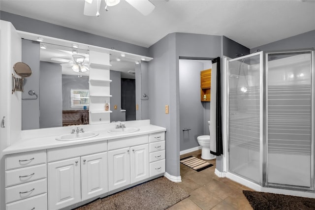 bathroom with a shower with door, vanity, ceiling fan, and toilet