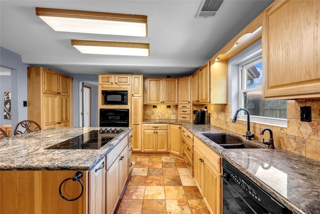 kitchen featuring black appliances, sink, dark stone counters, and tasteful backsplash