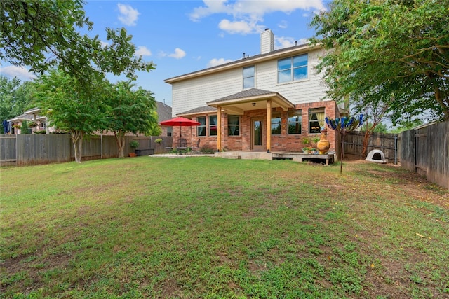 rear view of house with a lawn