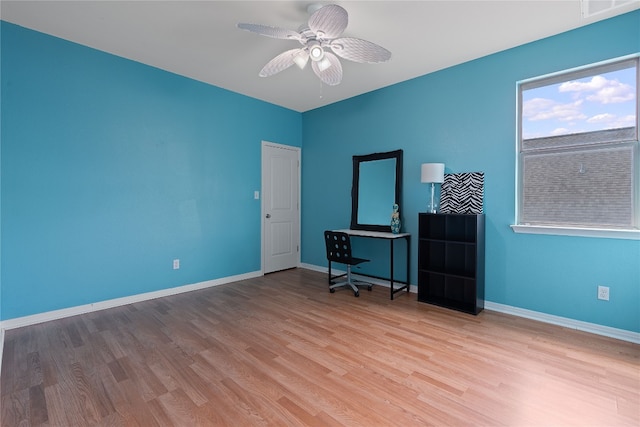 unfurnished office featuring light hardwood / wood-style flooring and ceiling fan