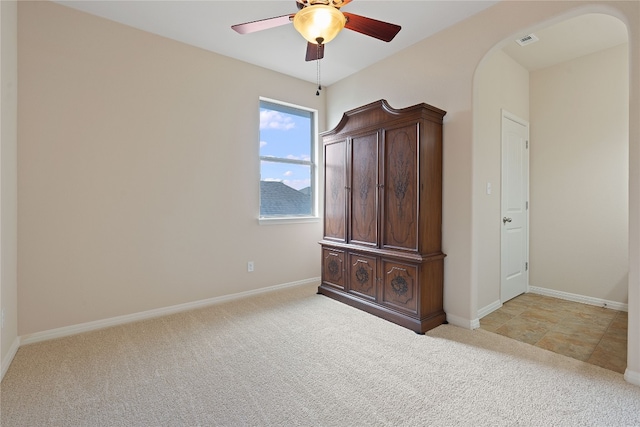 unfurnished bedroom with ceiling fan and light carpet