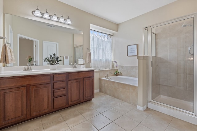 bathroom featuring vanity, separate shower and tub, and tile patterned floors