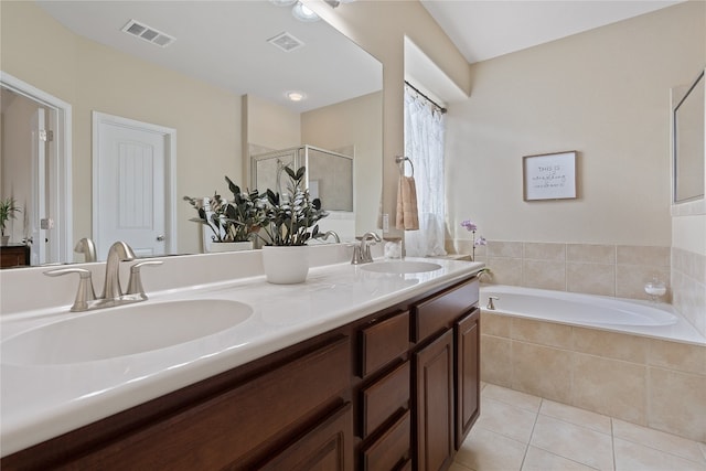 bathroom with shower with separate bathtub, tile patterned floors, and vanity