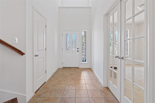 tiled entrance foyer featuring french doors