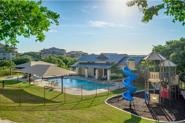 view of pool featuring a playground, a patio, and a lawn