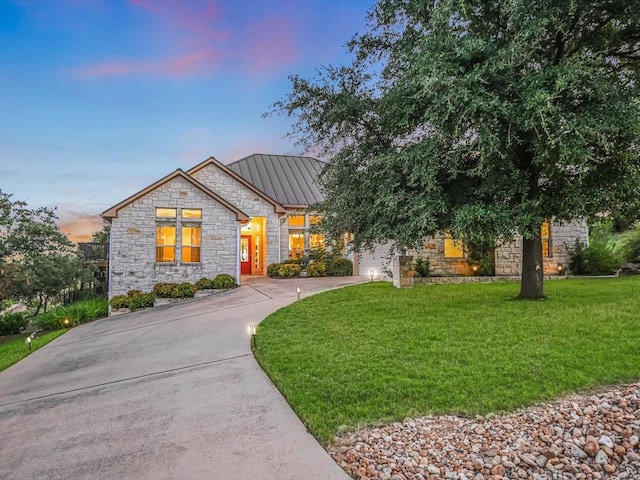 717 Fallow, Horseshoe Bay, TX 78657 - view of front of house with stone siding, a front yard, and driveway