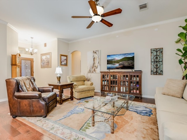 living room with ceiling fan with notable chandelier, hardwood / wood-style flooring, and ornamental molding