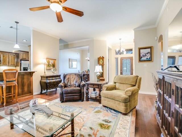 717 Fallow, Horseshoe Bay, TX 78657 - living area featuring hardwood / wood-style flooring, a chandelier, a ceiling fan, and ornamental molding
