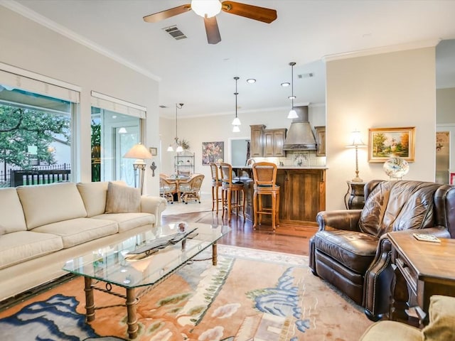 717 Fallow, Horseshoe Bay, TX 78657 - living area with a ceiling fan, crown molding, and light wood finished floors