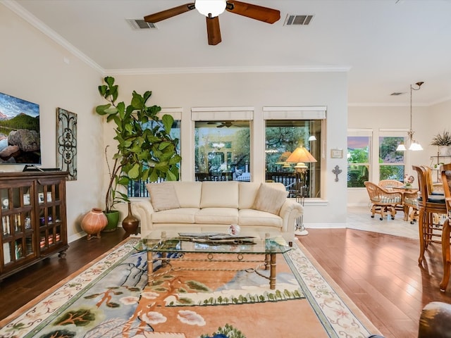 living room with crown molding, hardwood / wood-style flooring, and ceiling fan