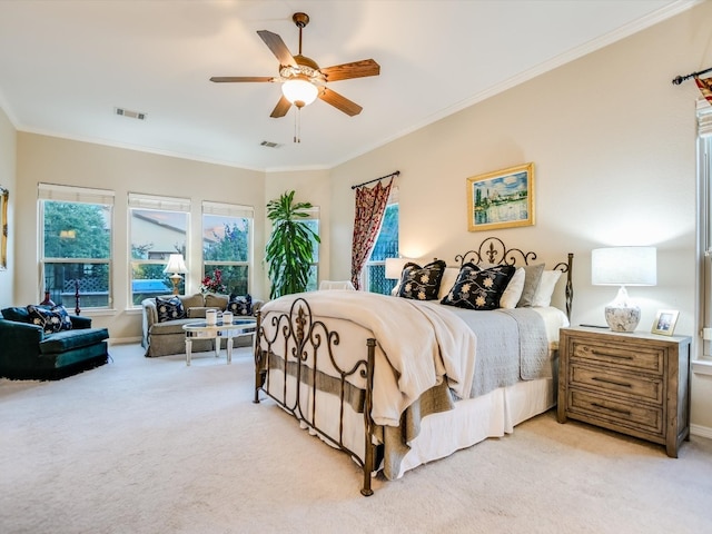 carpeted bedroom with ceiling fan and ornamental molding