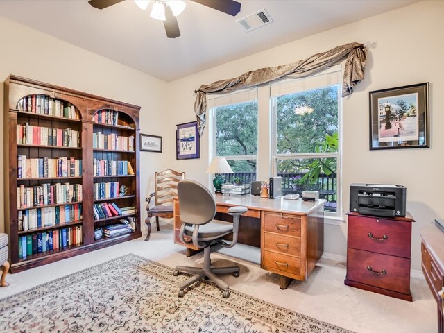 carpeted office featuring ceiling fan