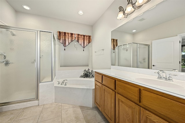 bathroom with tile patterned flooring, independent shower and bath, and vanity